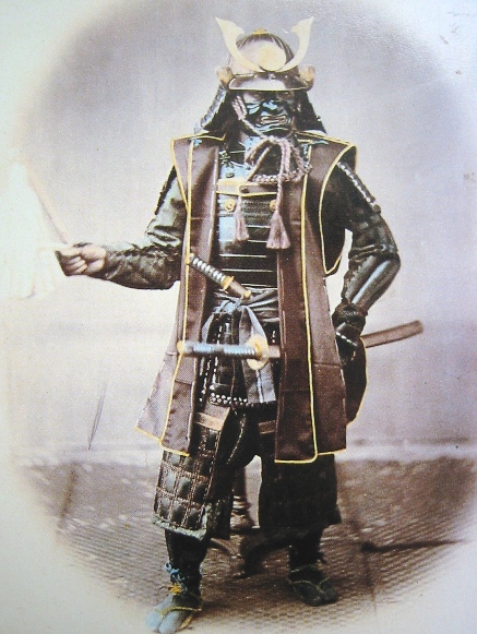 A rare hand coloured photograph of a Samurai in full armour Circa 1860's